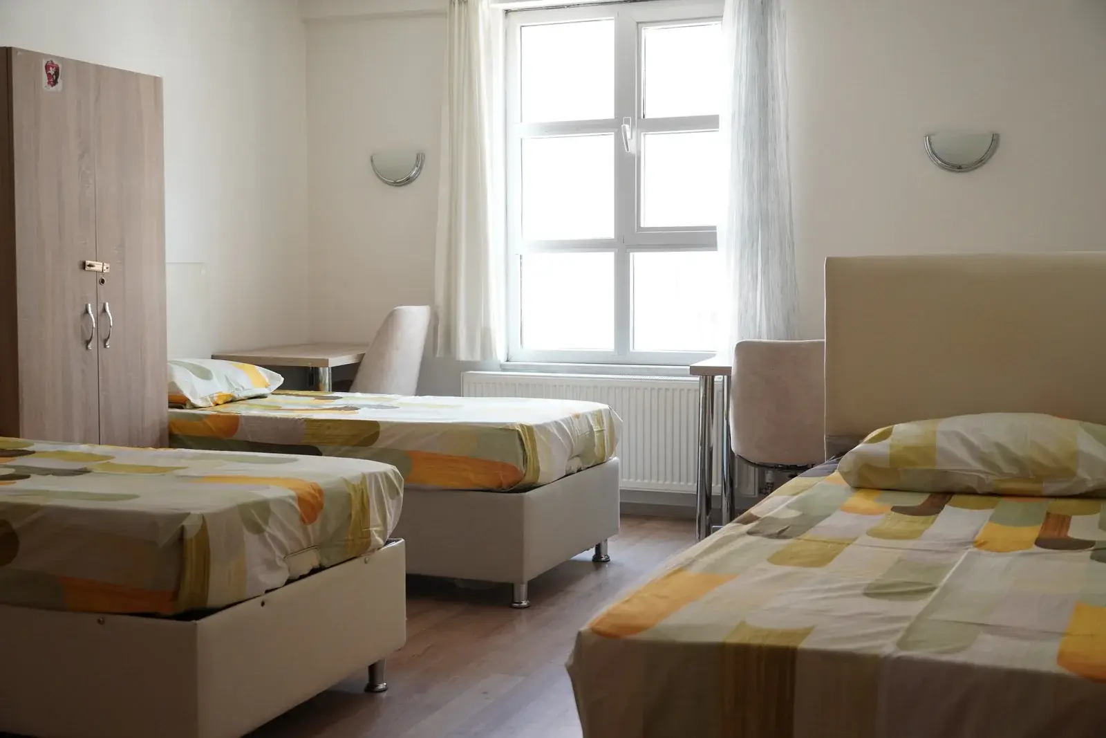 Dört kişilik oda — tek yataklar ve elbise dolapları